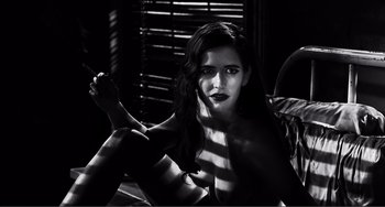 Movie still from “Sin City: A Dame to Kill For” (2014), directed by Frank Miller – A black - and - white photo of a woman sitting on a chair; Medium shot, Low angle