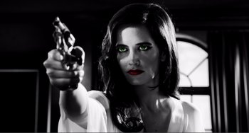 Movie still from “Sin City: A Dame to Kill For” (2014), directed by Frank Miller – A beautiful woman holding a gun with green eyes; Close Up shot, Low angle