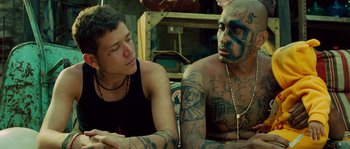 Movie still from “Sin Nombre” (2009), directed by Cary Joji Fukunaga – A man and a woman sitting next to each other; Medium shot, Over the shoulder angle