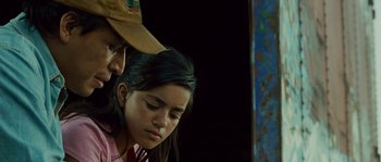 Movie still from “Sin Nombre” (2009), directed by Cary Joji Fukunaga – A man and a woman are looking at each other; Close Up shot, Low angle