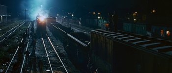 Movie still from “Sin Nombre” (2009), directed by Cary Joji Fukunaga – A man standing on top of a train platform; Extreme Wide shot, High angle