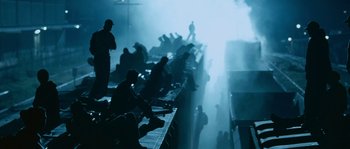 Movie still from “Sin Nombre” (2009), directed by Cary Joji Fukunaga – A group of people sitting on top of a platform; Extreme Wide shot, Low angle