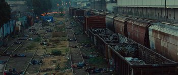 Movie still from “Sin Nombre” (2009), directed by Cary Joji Fukunaga – A couple of trains that are parked on the tracks; Extreme Wide shot, High angle