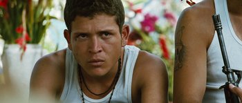 Movie still from “Sin Nombre” (2009), directed by Cary Joji Fukunaga – A person wearing a white shirt; Close Up shot, Low angle