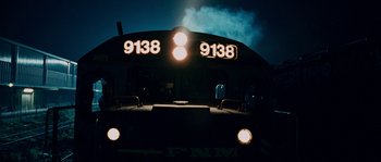 Movie still from “Sin Nombre” (2009), directed by Cary Joji Fukunaga – The front of a passenger train at night; Extreme Close Up shot, Low angle