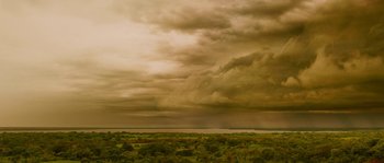 Movie still from “Sin Nombre” (2009), directed by Cary Joji Fukunaga – A cloudy sky over a large body of water; Extreme Wide shot, High angle