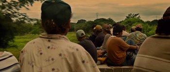 Movie still from “Sin Nombre” (2009), directed by Cary Joji Fukunaga – A group of people sitting on a bench; Wide shot, Over the shoulder angle