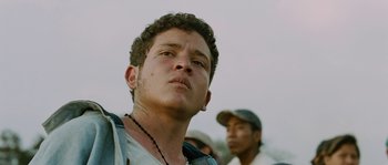 Movie still from “Sin Nombre” (2009), directed by Cary Joji Fukunaga – A person with a chain around his neck; Close Up shot, Low angle
