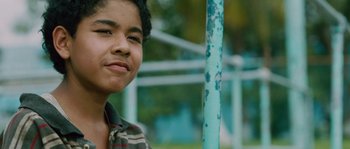 Movie still from “Sin Nombre” (2009), directed by Cary Joji Fukunaga – A young man standing next to a blue pole; Close Up shot, Low angle