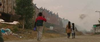 Movie still from “Sin Nombre” (2009), directed by Cary Joji Fukunaga – A man and a woman walking down a dirt road; Extreme Wide shot, Low angle