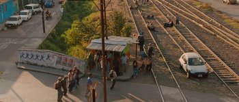 Movie still from “Sin Nombre” (2009), directed by Cary Joji Fukunaga – A group of people standing on the side of a train track; Extreme Wide shot, High angle