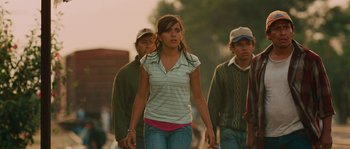 Movie still from “Sin Nombre” (2009), directed by Cary Joji Fukunaga – A group of people walking down a street; Medium shot, Low angle