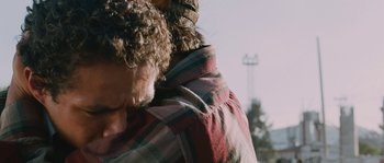 Movie still from “Sin Nombre” (2009), directed by Cary Joji Fukunaga – A person's face in a plaid shirt; Close Up shot, Over the shoulder angle