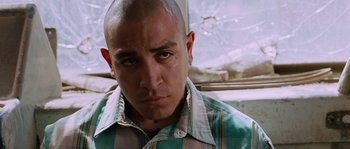 Movie still from “Sin Nombre” (2009), directed by Cary Joji Fukunaga – A person wearing a shirt; Close Up shot, Low angle