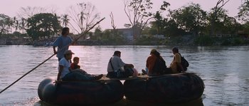 Movie still from “Sin Nombre” (2009), directed by Cary Joji Fukunaga – A group of people sitting on top of a boat; Wide shot, Low angle