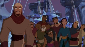 Movie still from “Sinbad: Legend of the Seven Seas” (2003), directed by Tim Johnson – A group of people standing next to each other in front of a ship; Medium shot, Over the shoulder angle