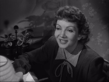 Movie still from “Since You Went Away” (1944), directed by John Cromwell – An old photo of a woman smiling at the camera; Close Up shot, Low angle