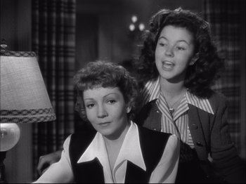 Movie still from “Since You Went Away” (1944), directed by John Cromwell – Two women are standing next to each other in a room; Medium shot, Low angle