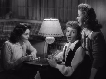 Movie still from “Since You Went Away” (1944), directed by John Cromwell – A group of women sitting around a table; Medium shot, Low angle