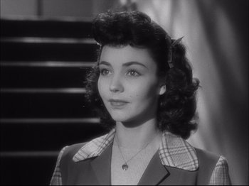 Movie still from “Since You Went Away” (1944), directed by John Cromwell – An old photo of a woman in a suit; Close Up shot, High angle