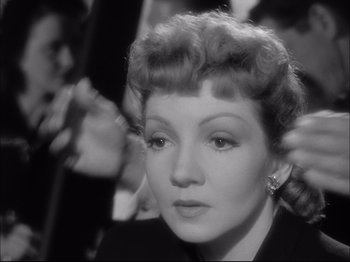 Movie still from “Since You Went Away” (1944), directed by John Cromwell – An old photo of a woman in a black suit; Close Up shot, Over the shoulder angle