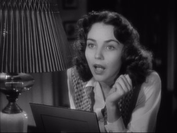 Movie still from “Since You Went Away” (1944), directed by John Cromwell – An old photo of a woman looking at a computer screen; Close Up shot, Low angle