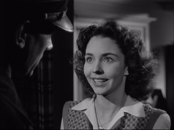 Movie still from “Since You Went Away” (1944), directed by John Cromwell – An old photo of a woman smiling at a man; Close Up shot, Over the shoulder angle