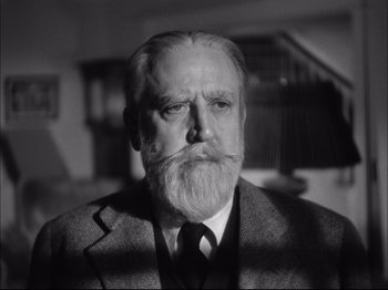 Movie still from “Since You Went Away” (1944), directed by John Cromwell – An older man with a beard and a suit and tie; Close Up shot, Low angle