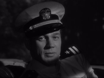 Movie still from “Since You Went Away” (1944), directed by John Cromwell – A black and white photo of a man in a uniform; Close Up shot, Low angle