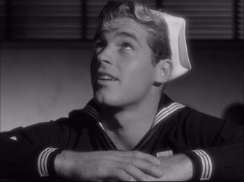 Movie still from “Since You Went Away” (1944), directed by John Cromwell – A man in a sailor's uniform looking up; Close Up shot, Low angle