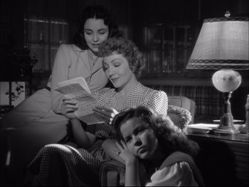 Movie still from “Since You Went Away” (1944), directed by John Cromwell – A group of women sitting in a living room reading; Medium shot, Low angle