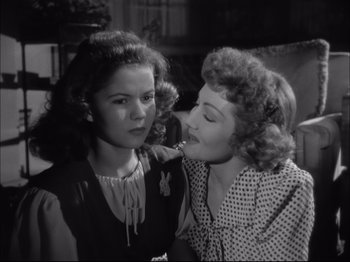 Movie still from “Since You Went Away” (1944), directed by John Cromwell – Two women are standing together and one of them has her mouth open; Close Up shot, Over the shoulder angle