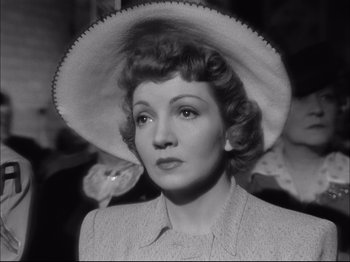 Movie still from “Since You Went Away” (1944), directed by John Cromwell – An old black and white photo of a woman wearing a hat; Close Up shot, Low angle