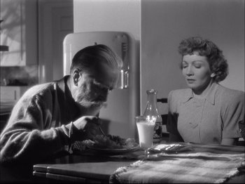 Movie still from “Since You Went Away” (1944), directed by John Cromwell – An older man and woman sitting at a table; Medium shot, High angle
