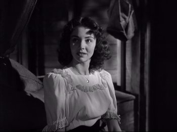 Movie still from “Since You Went Away” (1944), directed by John Cromwell – An old photo of a young woman in a white blouse; Close Up shot, Low angle