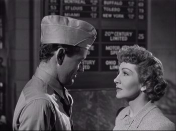 Movie still from “Since You Went Away” (1944), directed by John Cromwell – A man and a woman looking at one another; Medium shot, Low angle