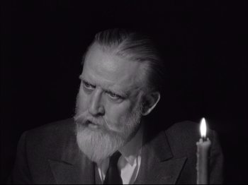 Movie still from “Since You Went Away” (1944), directed by John Cromwell – An old man with a beard and a candle in the dark; Close Up shot, Low angle