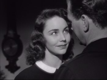 Movie still from “Since You Went Away” (1944), directed by John Cromwell – An old photo of a man and a woman looking at one another; Close Up shot, Over the shoulder angle