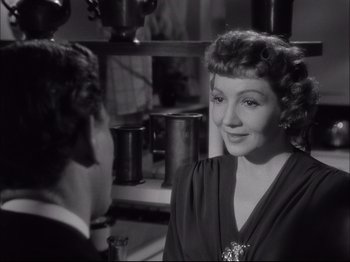 Movie still from “Since You Went Away” (1944), directed by John Cromwell – An old photo of a woman talking to a man; Close Up shot, Over the shoulder angle