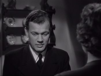 Movie still from “Since You Went Away” (1944), directed by John Cromwell – A man wearing a suit and tie in a room; Close Up shot, Over the shoulder angle