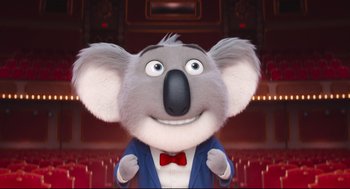 Movie still from “Sing” (2016), directed by Christophe Lourdelet – A koala in a suit and bow tie; Medium shot, Low angle