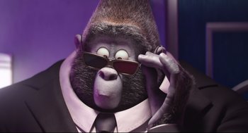 Movie still from “Sing” (2016), directed by Christophe Lourdelet – A gorilla wearing a suit and sunglasses; Close Up shot, Low angle