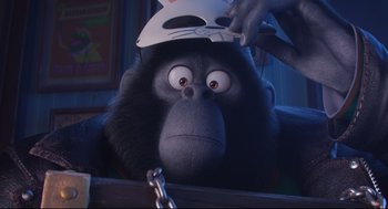 Movie still from “Sing” (2016), directed by Christophe Lourdelet – A monkey with a helmet on his head; Close Up shot, Low angle