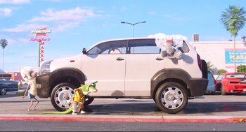 Movie still from “Sing” (2016), directed by Christophe Lourdelet – A white suv parked on the side of the road; Wide shot, Low angle