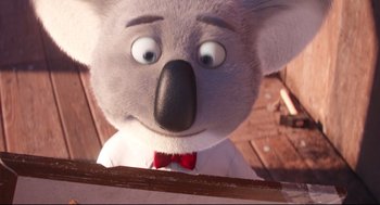 Movie still from “Sing” (2016), directed by Christophe Lourdelet – A koala bear wearing a red bow tie; Close Up shot, Low angle
