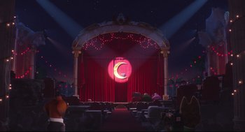 Movie still from “Sing” (2016), directed by Christophe Lourdelet – A stage with red curtains and a moon on the stage; Wide shot, Low angle