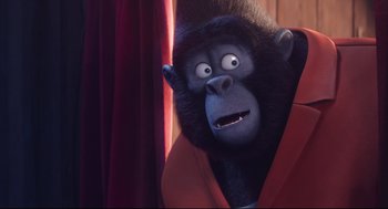 Movie still from “Sing” (2016), directed by Christophe Lourdelet – A gorilla with a surprised look on his face; Close Up shot, Over the shoulder angle