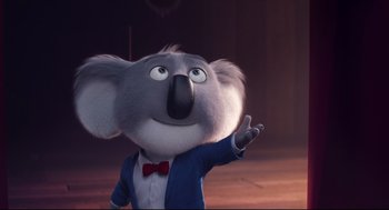 Movie still from “Sing” (2016), directed by Christophe Lourdelet – A koala character is waving to the camera; Medium shot, Low angle