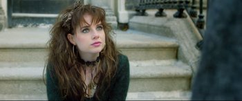 Movie still from “Sing Street” (2016), directed by John Carney – A woman sitting on some steps wearing a tiara; Close Up shot, Over the shoulder angle