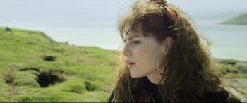 Movie still from “Sing Street” (2016), directed by John Carney – A person with long brown hair; Close Up shot, Low angle